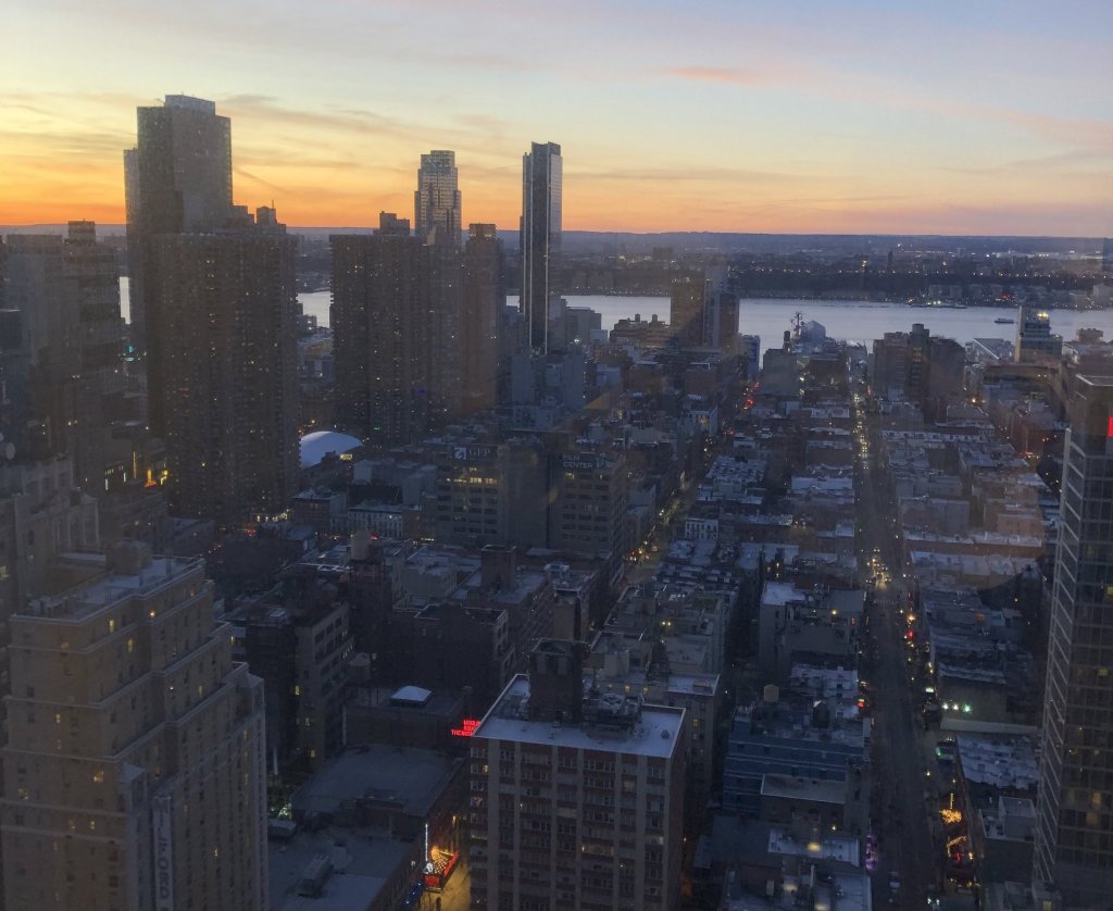 City skyline with lit windows at dusk